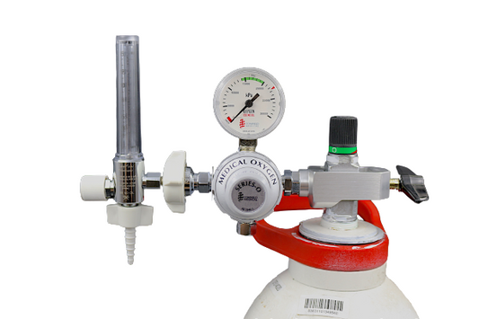 Comweld Series O medical oxygen regulator mounted on D-size oxygen cylinder with flowmeter rotameter attached showing in-use configuration